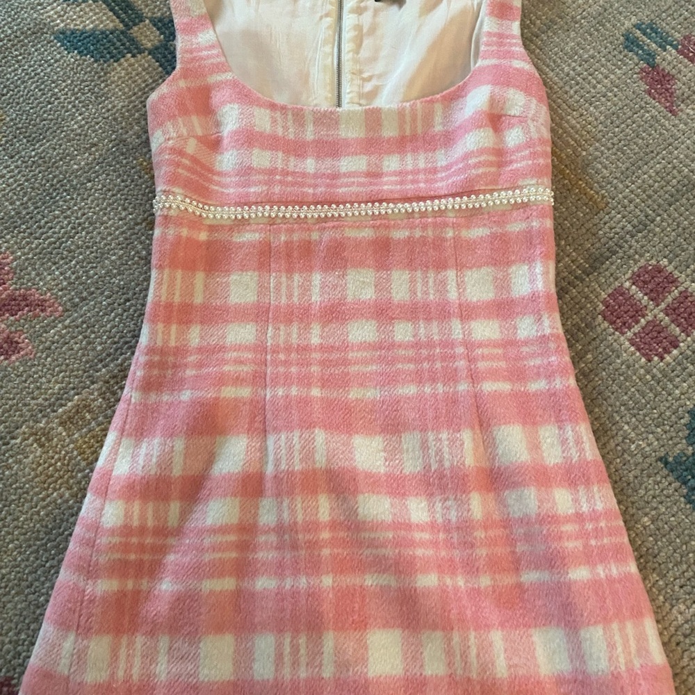 - Cute pink and beige checked lined dress with pearl trim above the waist